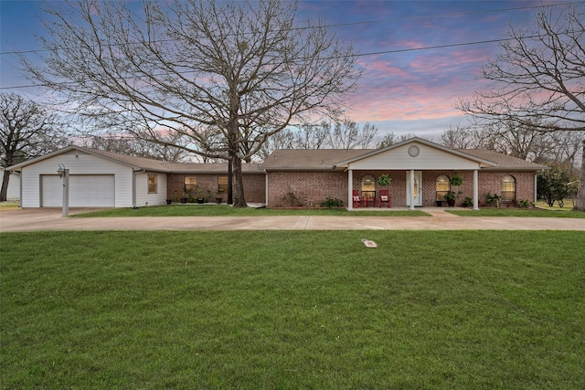 view of front of property with driveway, brick siding, and a front yard