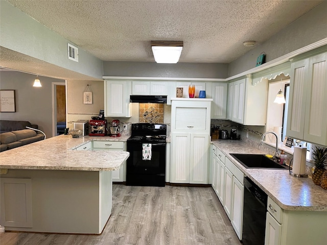 kitchen featuring a sink, light wood-type flooring, a peninsula, black appliances, and exhaust hood