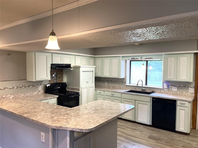 806 Robindale Ln, Fairfield, TX 75840 - kitchen featuring black appliances, light countertops, tasteful backsplash, a peninsula, and under cabinet range hood