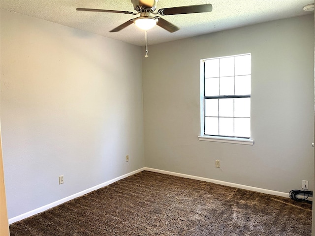 carpeted empty room featuring a textured ceiling, a ceiling fan, and baseboards