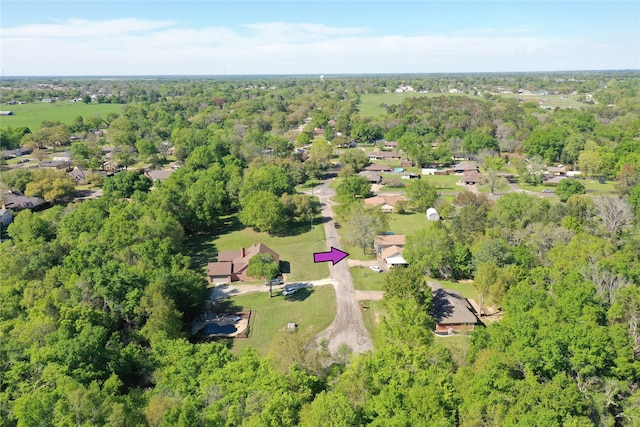 birds eye view of property featuring a forest view