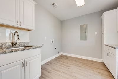 laundry area with hookup for a washing machine, visible vents, a sink, electric dryer hookup, and electric panel