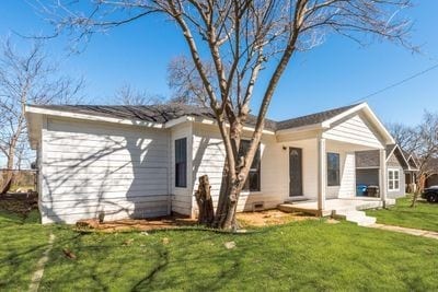 exterior space with a front lawn and a patio