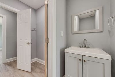 bathroom featuring vanity, baseboards, and wood finished floors