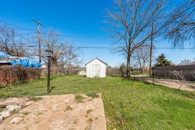 view of yard with a shed and an outbuilding