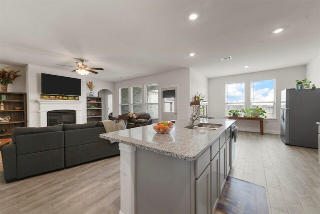 3512 Tunnel Ave, Aubrey, TX 76227 - kitchen featuring appliances with stainless steel finishes, a sink, light wood-type flooring, light stone countertops, and recessed lighting