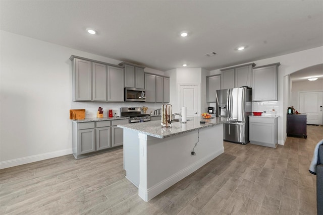 3512 Tunnel Ave, Aubrey, TX 76227 - kitchen with appliances with stainless steel finishes, gray cabinets, arched walkways, and recessed lighting
