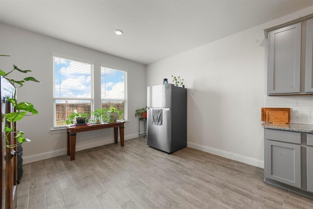 3512 Tunnel Ave, Aubrey, TX 76227 - kitchen featuring freestanding refrigerator, gray cabinetry, light wood-style flooring, and baseboards