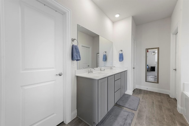 3512 Tunnel Ave, Aubrey, TX 76227 - full bathroom with double vanity, wood finished floors, and baseboards