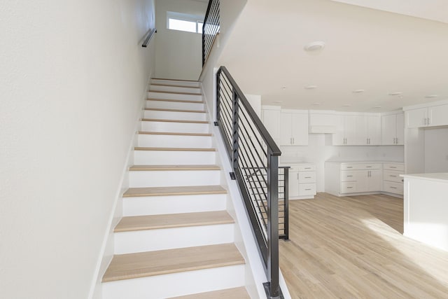 stairs with wood finished floors