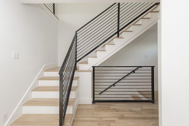 staircase featuring wood finished floors