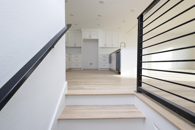 stairway with wood finished floors