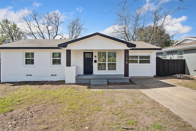 ranch-style home featuring an attached garage, brick siding, fence, driveway, and crawl space