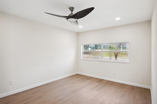 spare room with light wood-type flooring, ceiling fan, baseboards, and recessed lighting