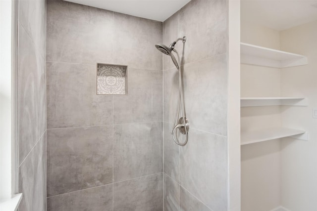 full bathroom with tiled shower