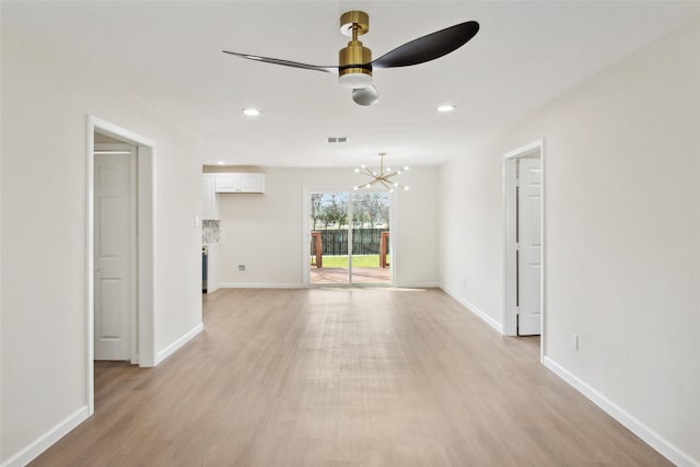 interior space with recessed lighting, visible vents, light wood-type flooring, baseboards, and ceiling fan with notable chandelier