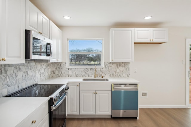 kitchen with tasteful backsplash, stainless steel microwave, electric range, a sink, and dishwashing machine