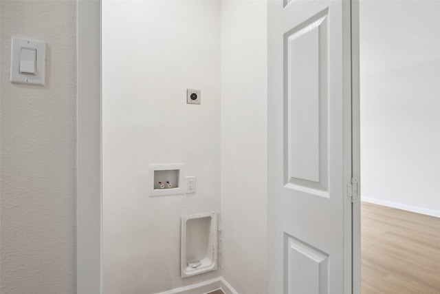 clothes washing area featuring laundry area, baseboards, wood finished floors, hookup for a washing machine, and electric dryer hookup