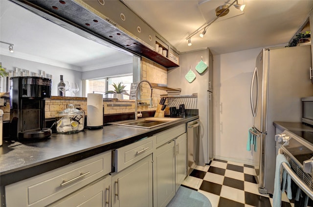 kitchen featuring open shelves, stainless steel appliances, a sink, light floors, and dark countertops