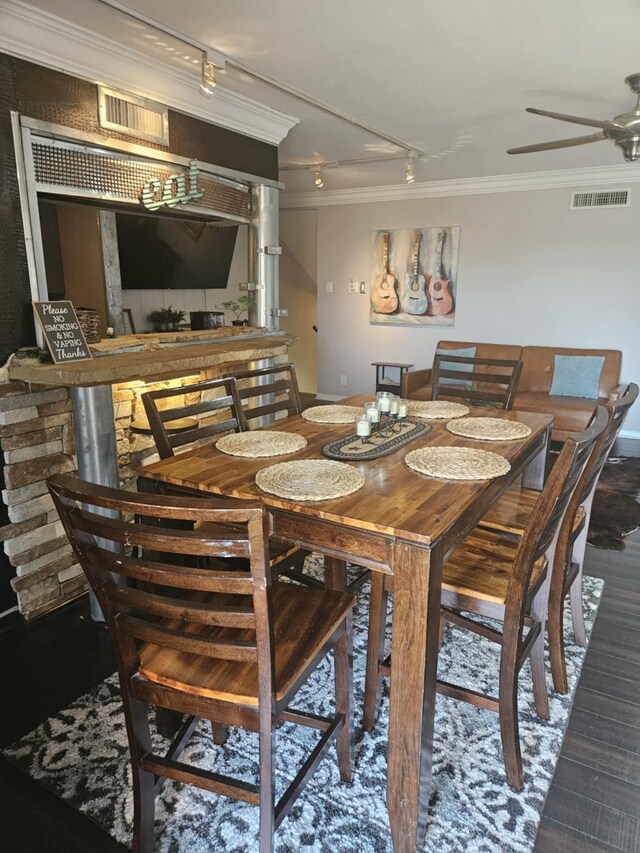 dining area with ornamental molding, visible vents, and a ceiling fan