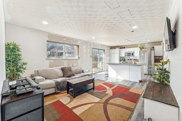 living room featuring light wood-type flooring and recessed lighting