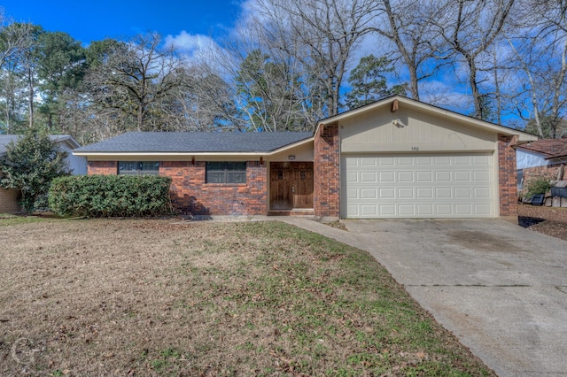 single story home with concrete driveway, brick siding, an attached garage, and a front yard