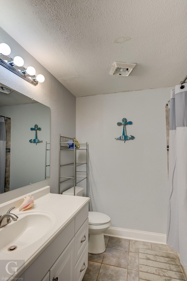 full bath with visible vents, toilet, vanity, a textured ceiling, and baseboards