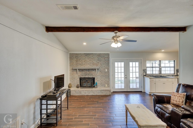 living room featuring dark wood-type flooring, french doors, visible vents, and lofted ceiling with beams