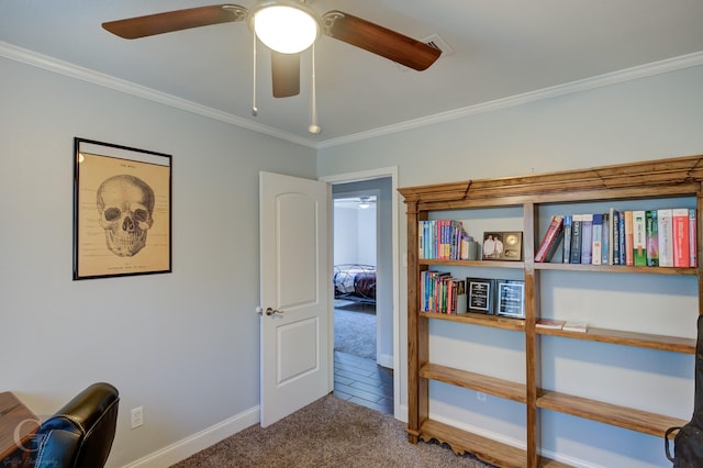 interior space featuring a ceiling fan, carpet, crown molding, and baseboards