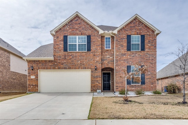 traditional-style home with a garage, roof with shingles, concrete driveway, and brick siding