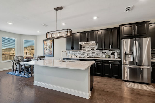 kitchen featuring light countertops, visible vents, decorative backsplash, appliances with stainless steel finishes, and a sink