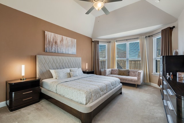 bedroom with lofted ceiling, light carpet, a ceiling fan, and baseboards