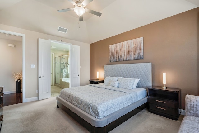 bedroom with carpet floors, lofted ceiling, visible vents, connected bathroom, and baseboards