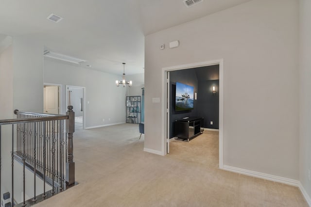 corridor featuring an upstairs landing, carpet flooring, and visible vents