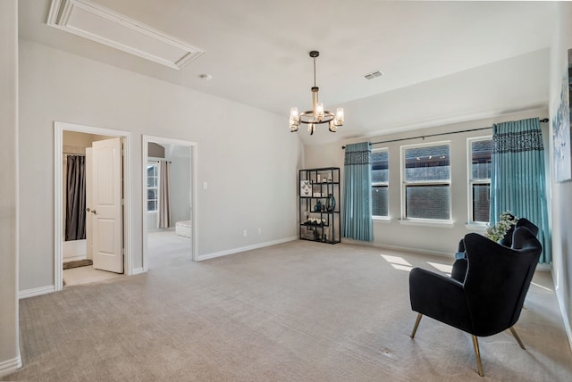 sitting room featuring visible vents, carpet floors, a wealth of natural light, and attic access