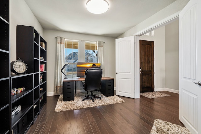 office with dark wood-style floors and baseboards