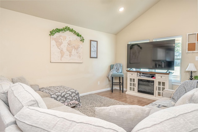 living room featuring recessed lighting, vaulted ceiling, baseboards, and wood finished floors