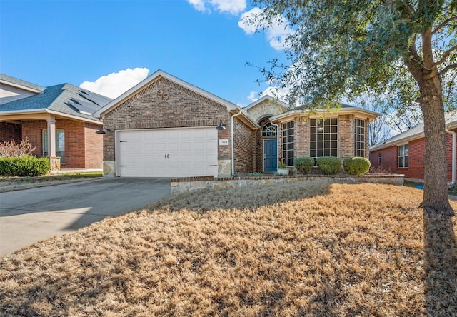 ranch-style house featuring driveway, a garage, and brick siding