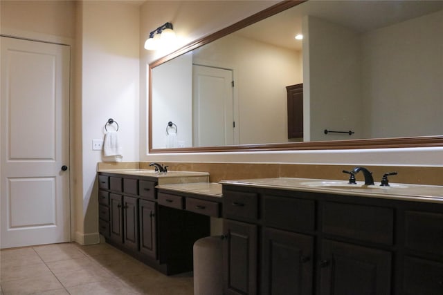 full bathroom featuring double vanity, a sink, and tile patterned floors