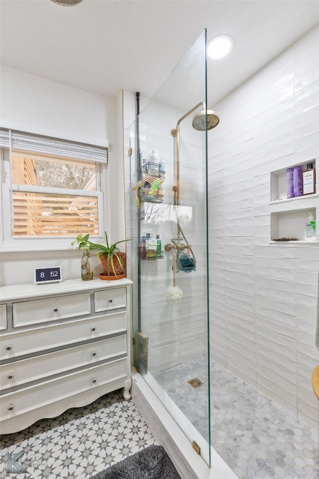 bathroom with a walk in shower and tile patterned floors