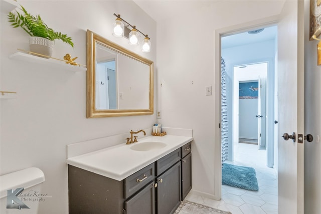 1258 Canterbury Dr, Abilene, TX 79602 - bathroom featuring vanity, tile patterned floors, and toilet