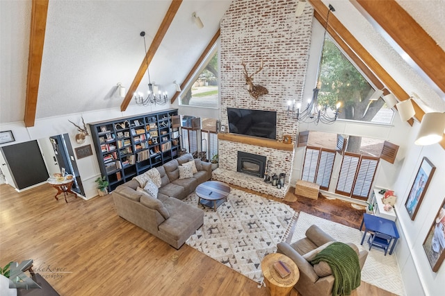 1258 Canterbury Dr, Abilene, TX 79602 - living room with a chandelier, beam ceiling, high vaulted ceiling, wood finished floors, and a fireplace