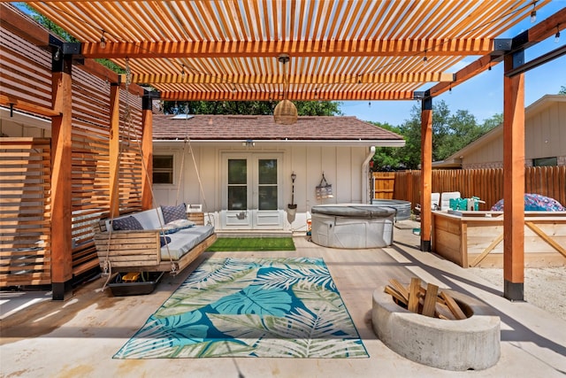 1258 Canterbury Dr, Abilene, TX 79602 - view of patio featuring french doors, a hot tub, fence, and an outdoor living space with a fire pit