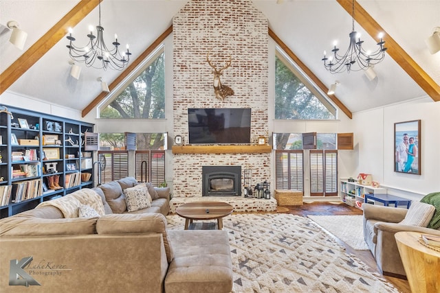 living area featuring an inviting chandelier, a fireplace, high vaulted ceiling, and beam ceiling