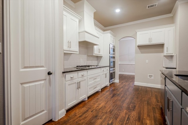 kitchen with visible vents, white cabinets, dark wood finished floors, appliances with stainless steel finishes, and custom exhaust hood