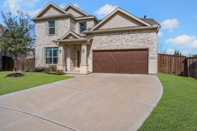 view of front of house with stone siding, driveway, a front yard, and fence