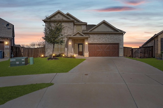 view of front of property featuring driveway, an attached garage, a front lawn, and fence