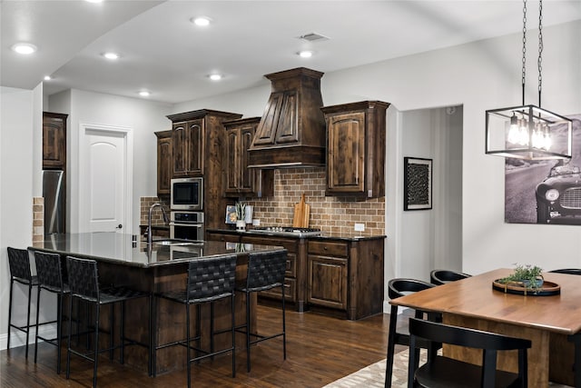 kitchen with visible vents, custom exhaust hood, stainless steel appliances, and dark brown cabinets