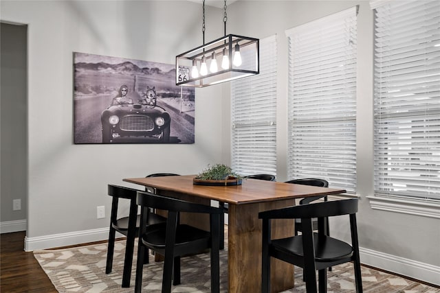 dining area featuring baseboards and wood finished floors