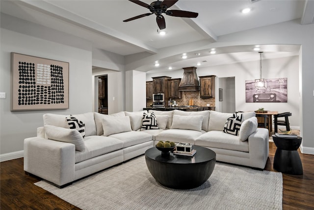 living room featuring baseboards, dark wood-style flooring, beamed ceiling, and recessed lighting